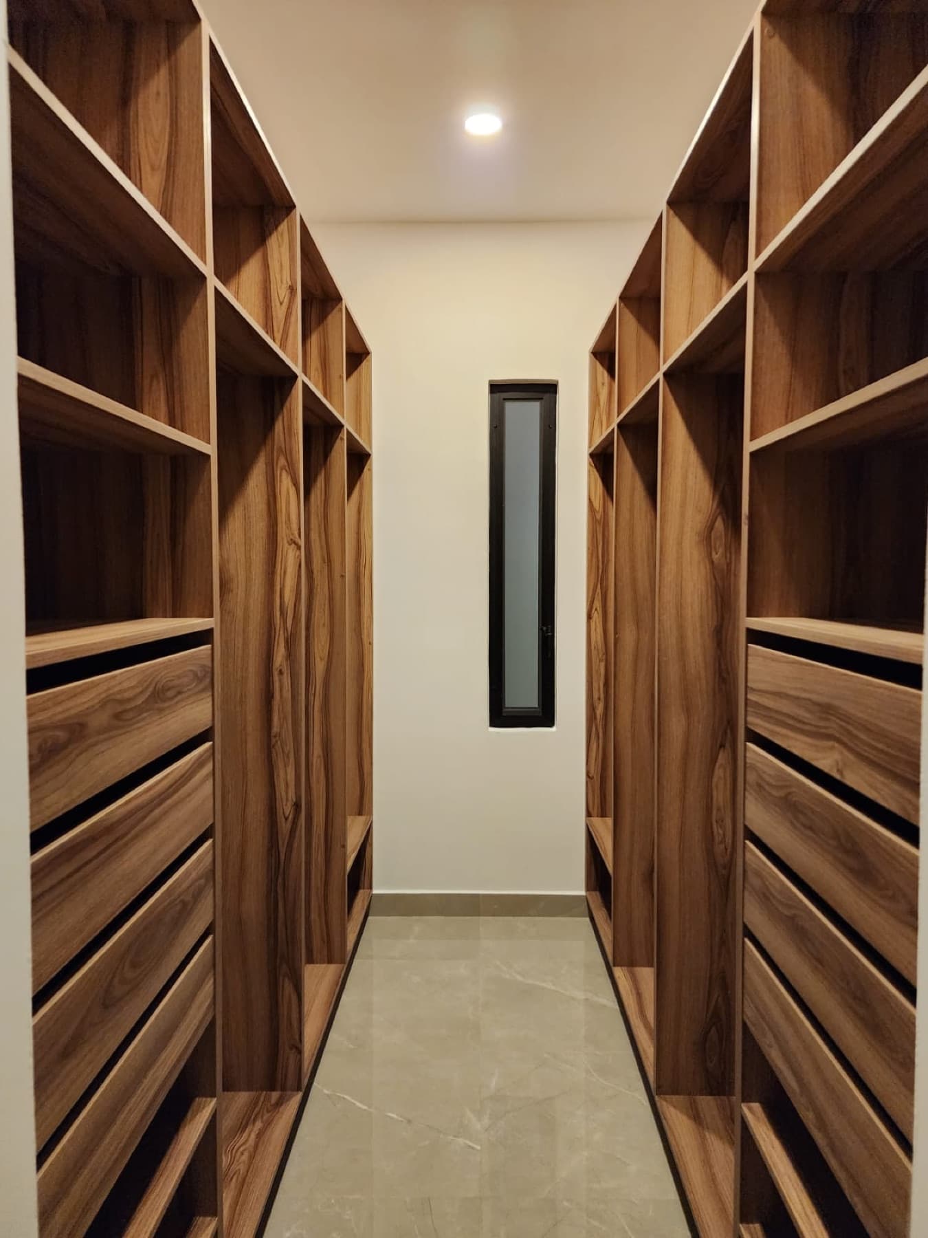 Walk-in closet with wood cabinetry